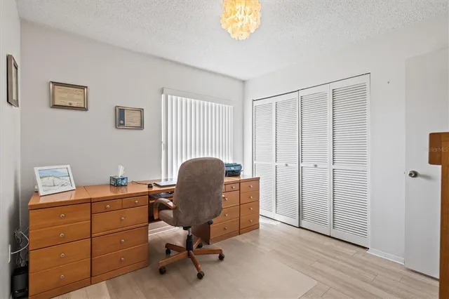 a view of a dining room with furniture and a chandelier