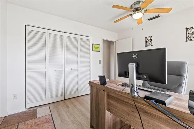 a backyard of a house with plants and wooden fence