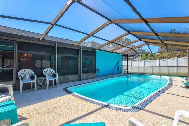 a view of a tennis ground with large trees