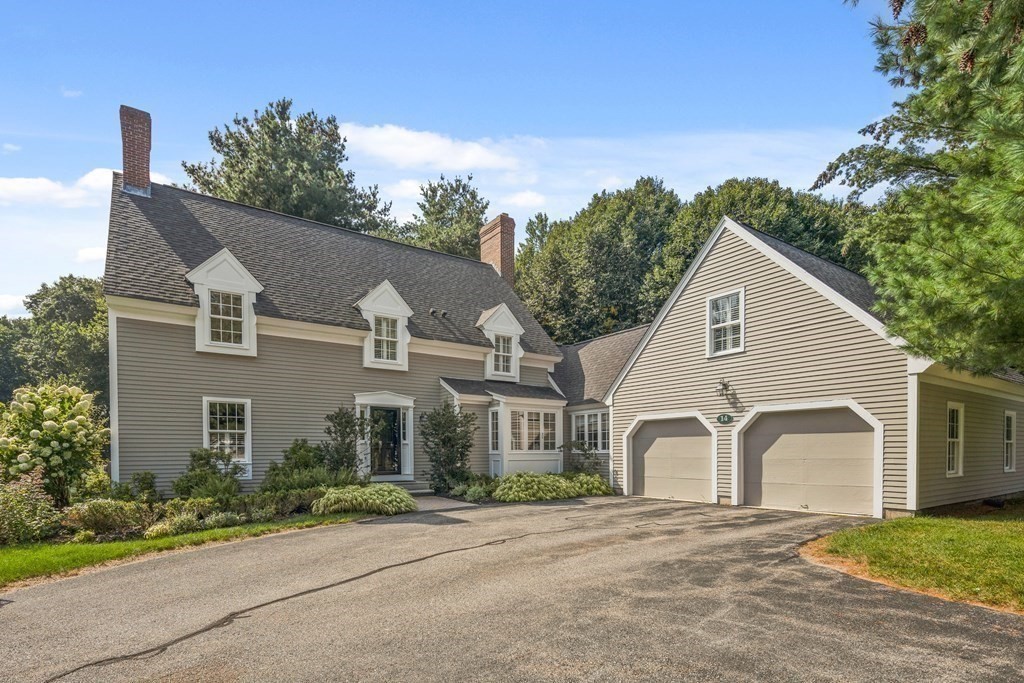 14 Wright Farm Concord, MA 01742 - Photo 2 of 34 a view of a white house with a yard and plants