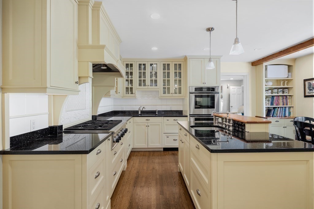 14 Wright Farm Concord, MA 01742 - Photo 4 of 34 a kitchen with granite countertop a sink a counter space appliances and cabinets