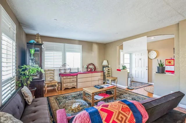 a bedroom with furniture and a wooden floor