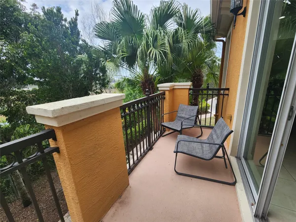 a view of a balcony with furniture