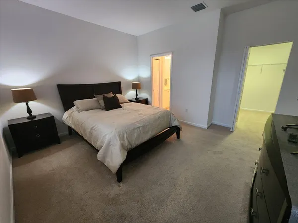 a bedroom with a bed and a couch