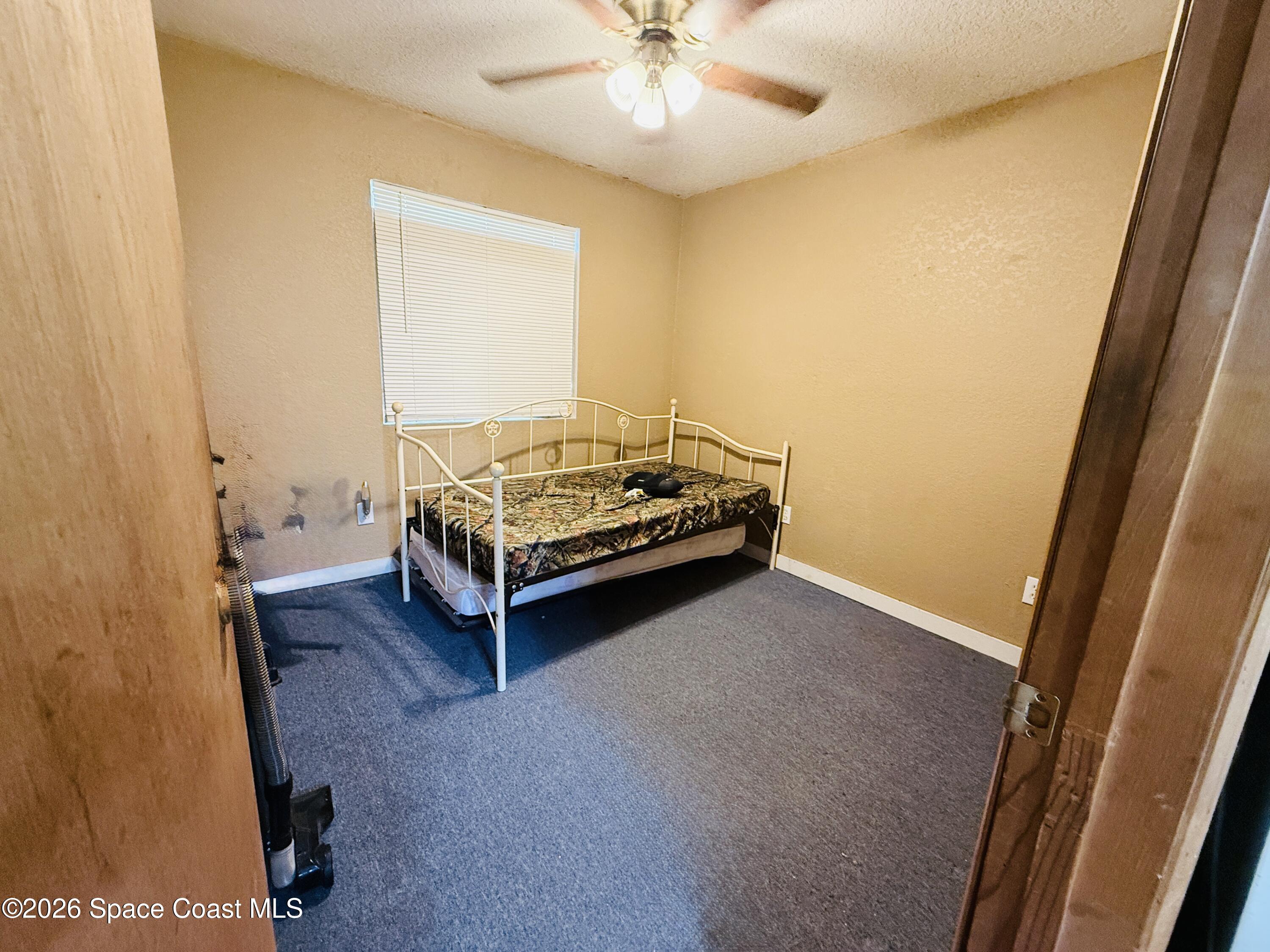 4590 Hog Valley Road Mims, FL 32754 - Photo 13 of 29 a room with a bed and a table