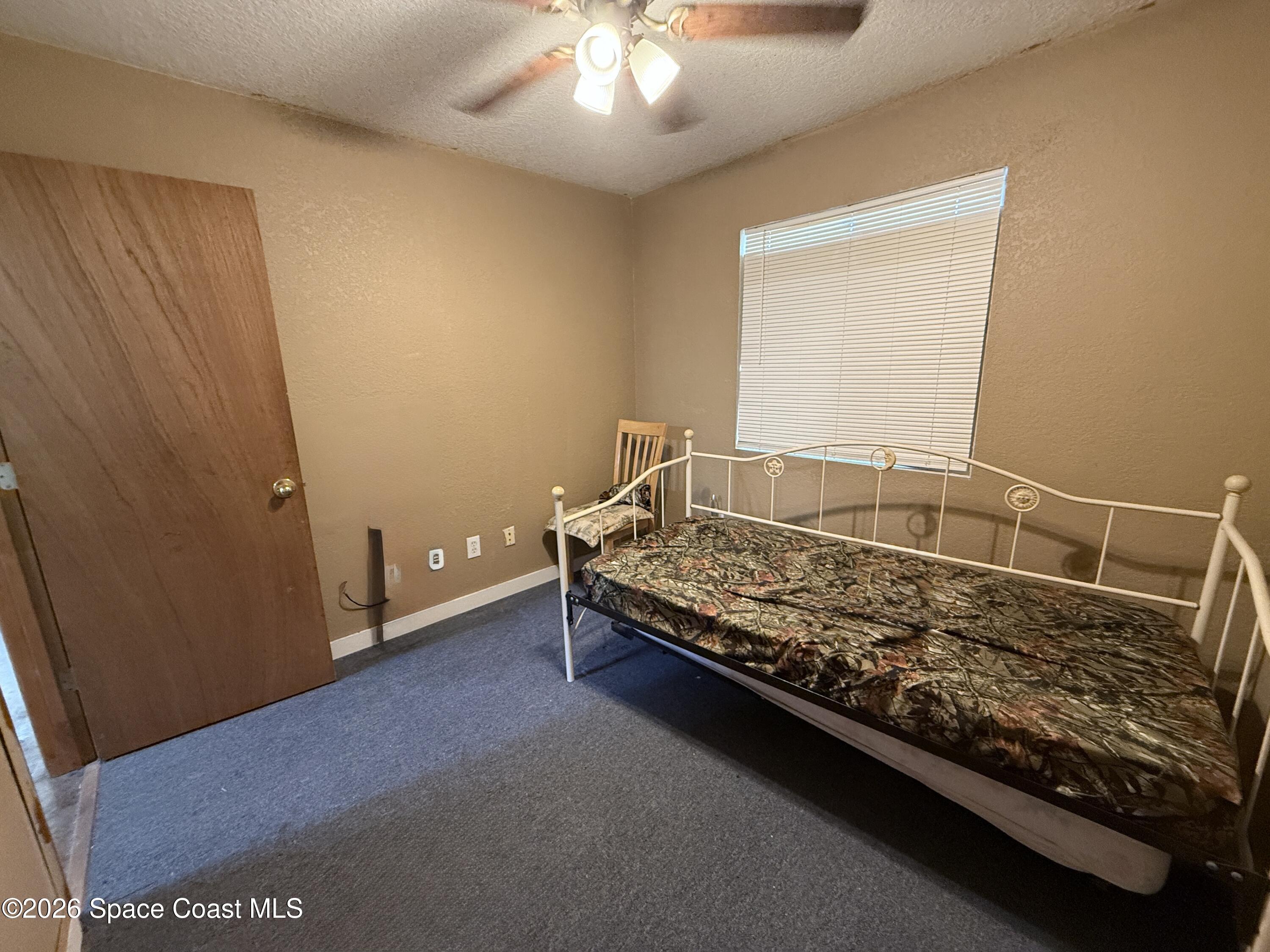 4590 Hog Valley Road Mims, FL 32754 - Photo 14 of 29 a bed sitting in a room next to a window