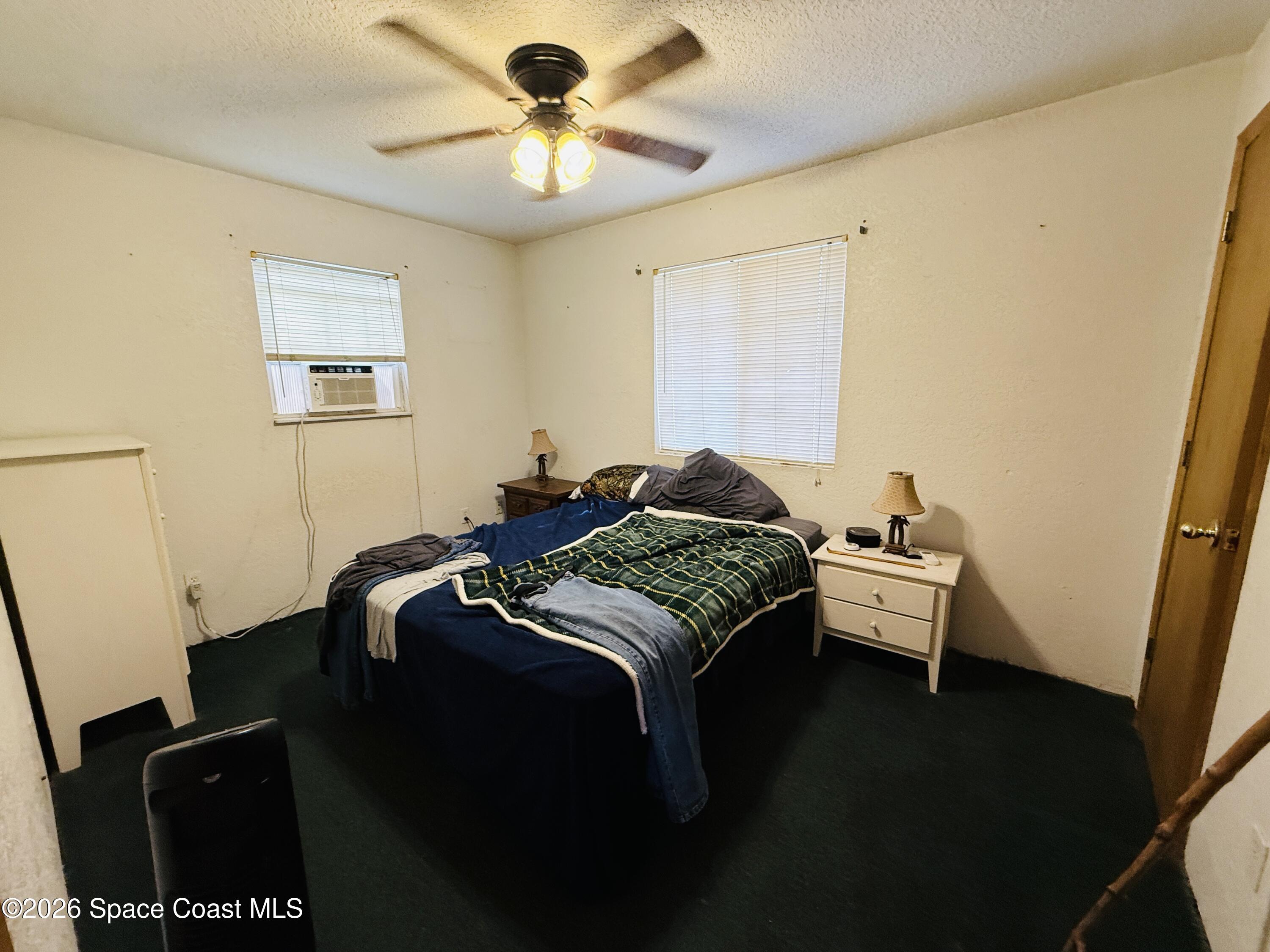4590 Hog Valley Road Mims, FL 32754 - Photo 15 of 29 a bedroom with a bed and a window