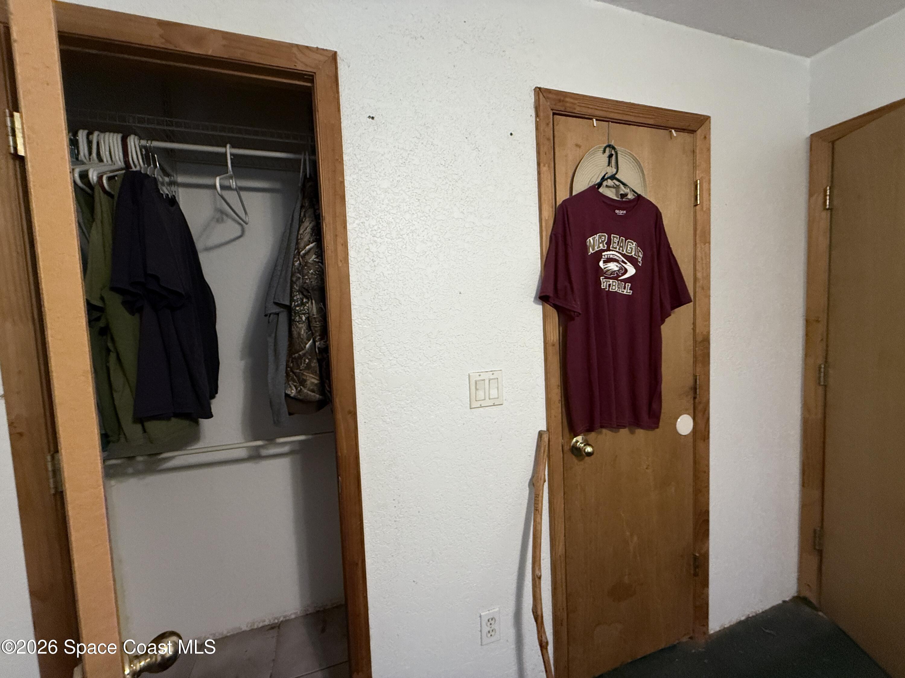 4590 Hog Valley Road Mims, FL 32754 - Photo 16 of 29 a view of walk in closet with clothes and shoes
