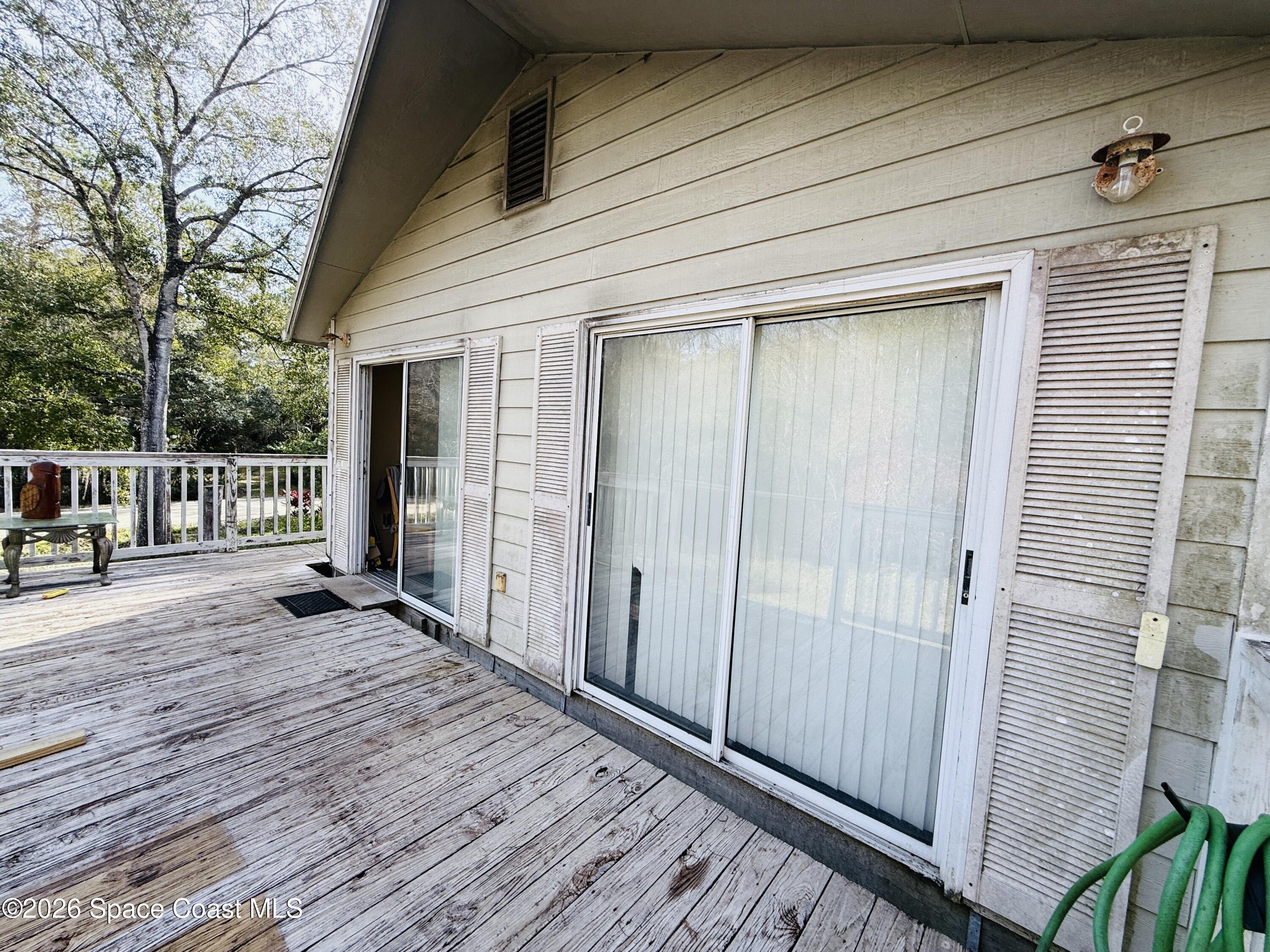 4590 Hog Valley Road Mims, FL 32754 - Photo 20 of 29 a view of a porch with wooden floor and fence