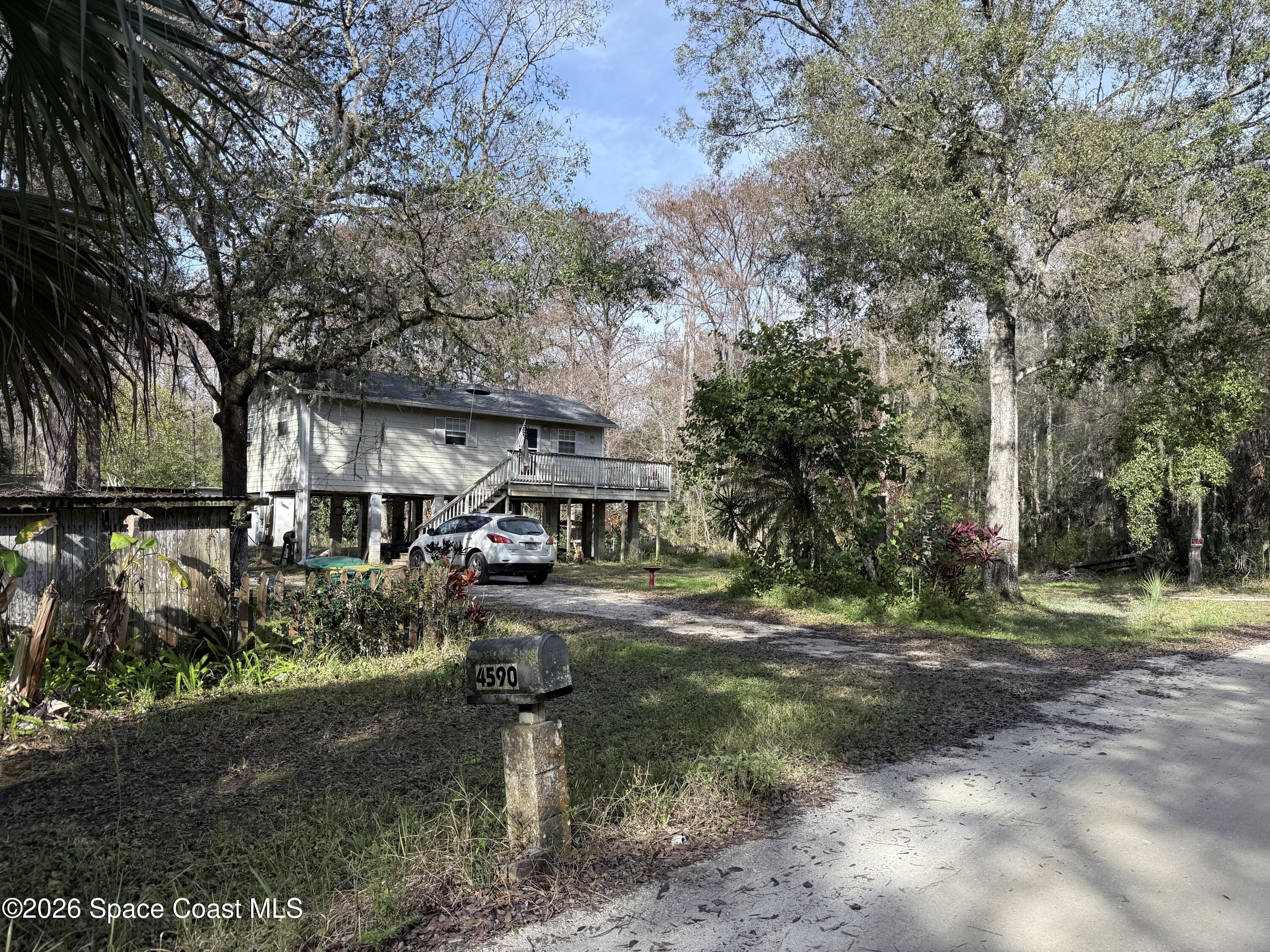 4590 Hog Valley Road Mims, FL 32754 - Photo 3 of 29 a front view of a house with garden