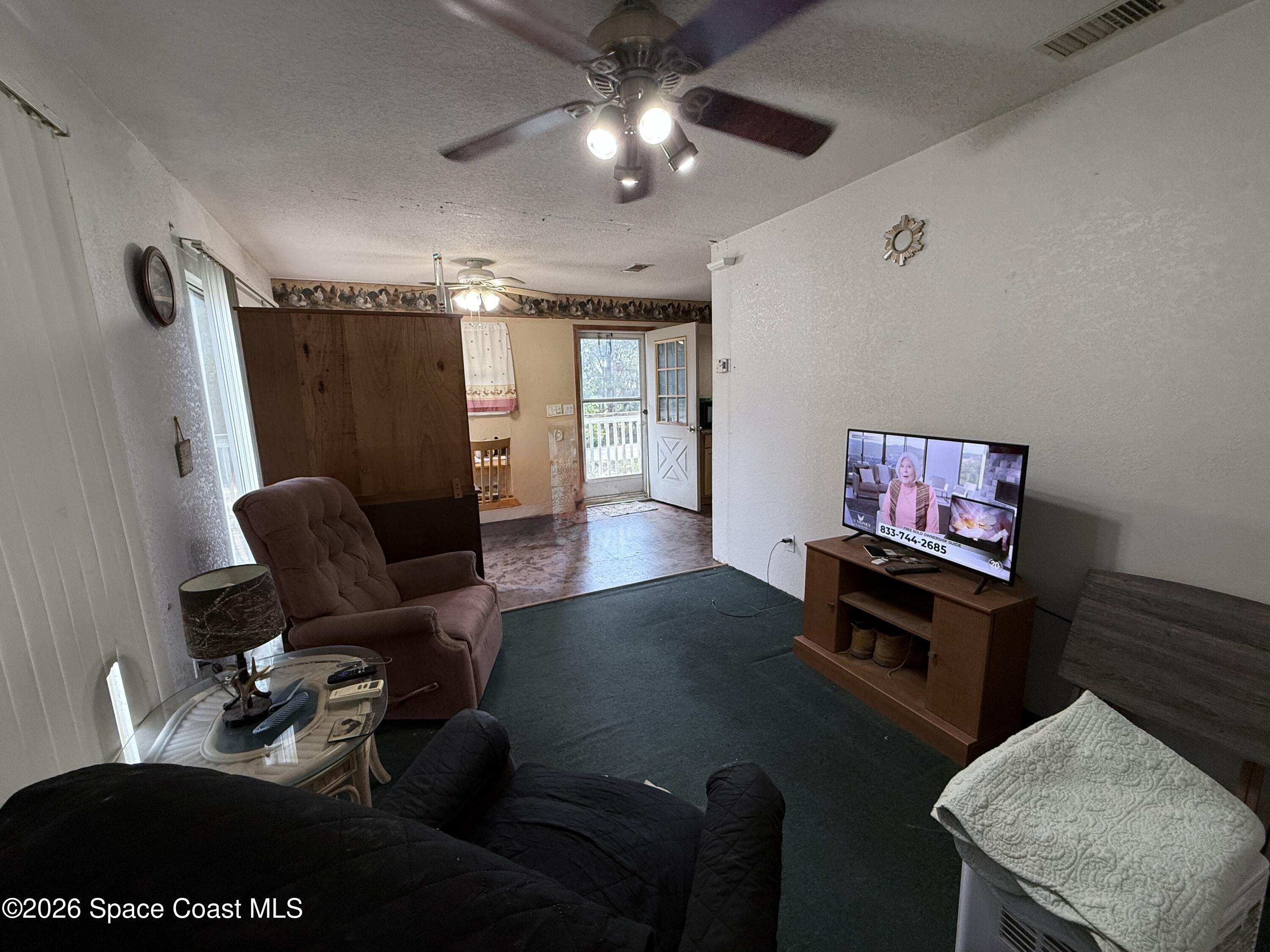 4590 Hog Valley Road Mims, FL 32754 - Photo 7 of 29 a living room with furniture and a flat screen tv