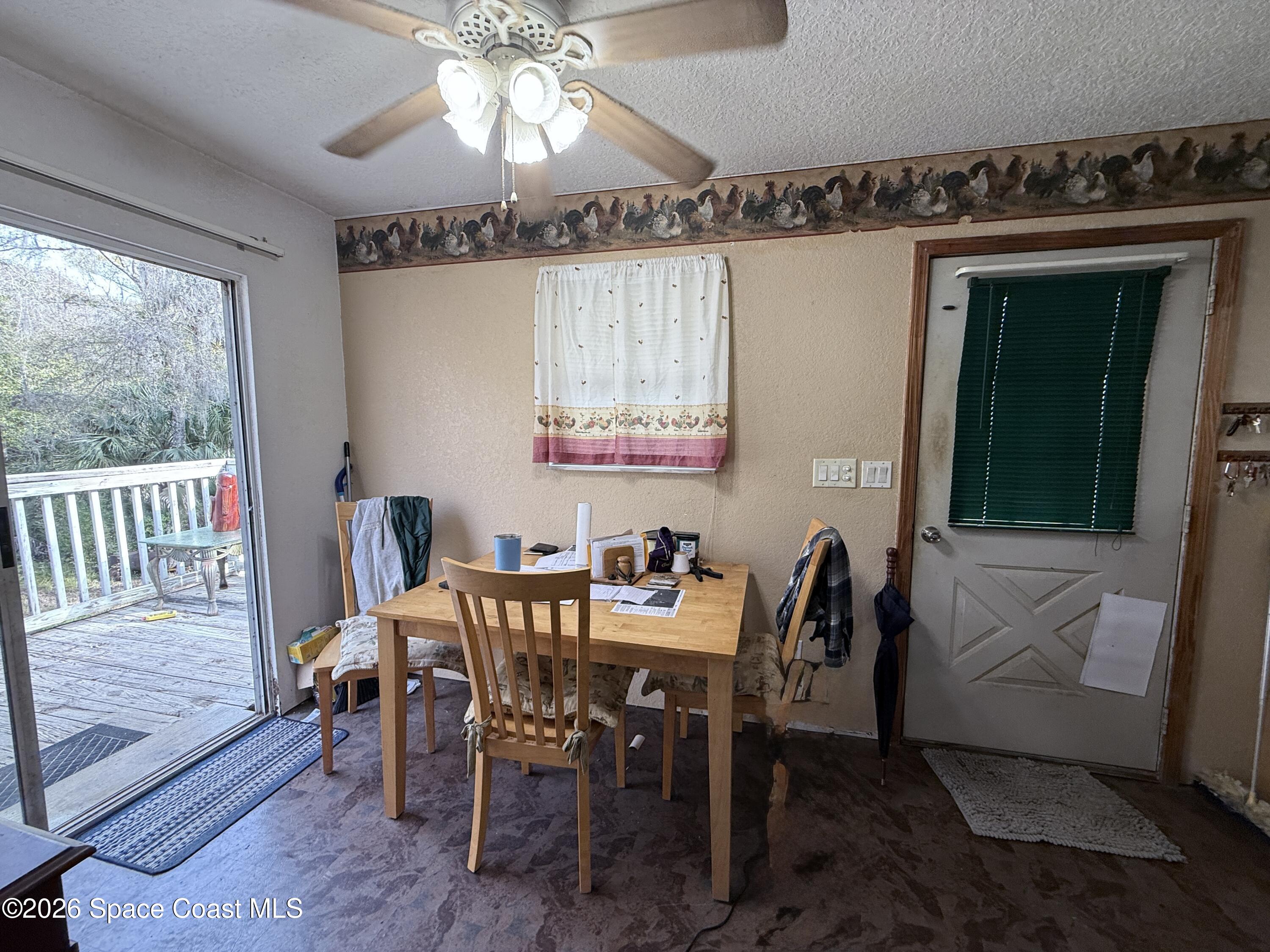 4590 Hog Valley Road Mims, FL 32754 - Photo 10 of 29 a view of a dining room with furniture window and wooden floor
