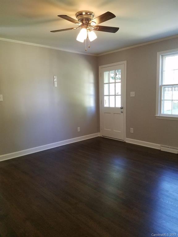 543 Scaleybark Road Charlotte, NC 28209 - Photo 14 of 24 a view of an empty room with wooden floor and a window