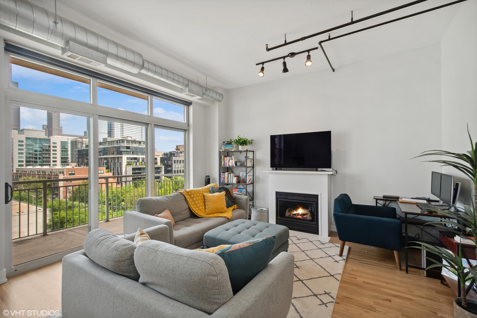 950 West Monroe Street, Unit 602 Chicago, IL 60607 - Photo 3 of 14 a living room with furniture a flat screen tv and a fireplace