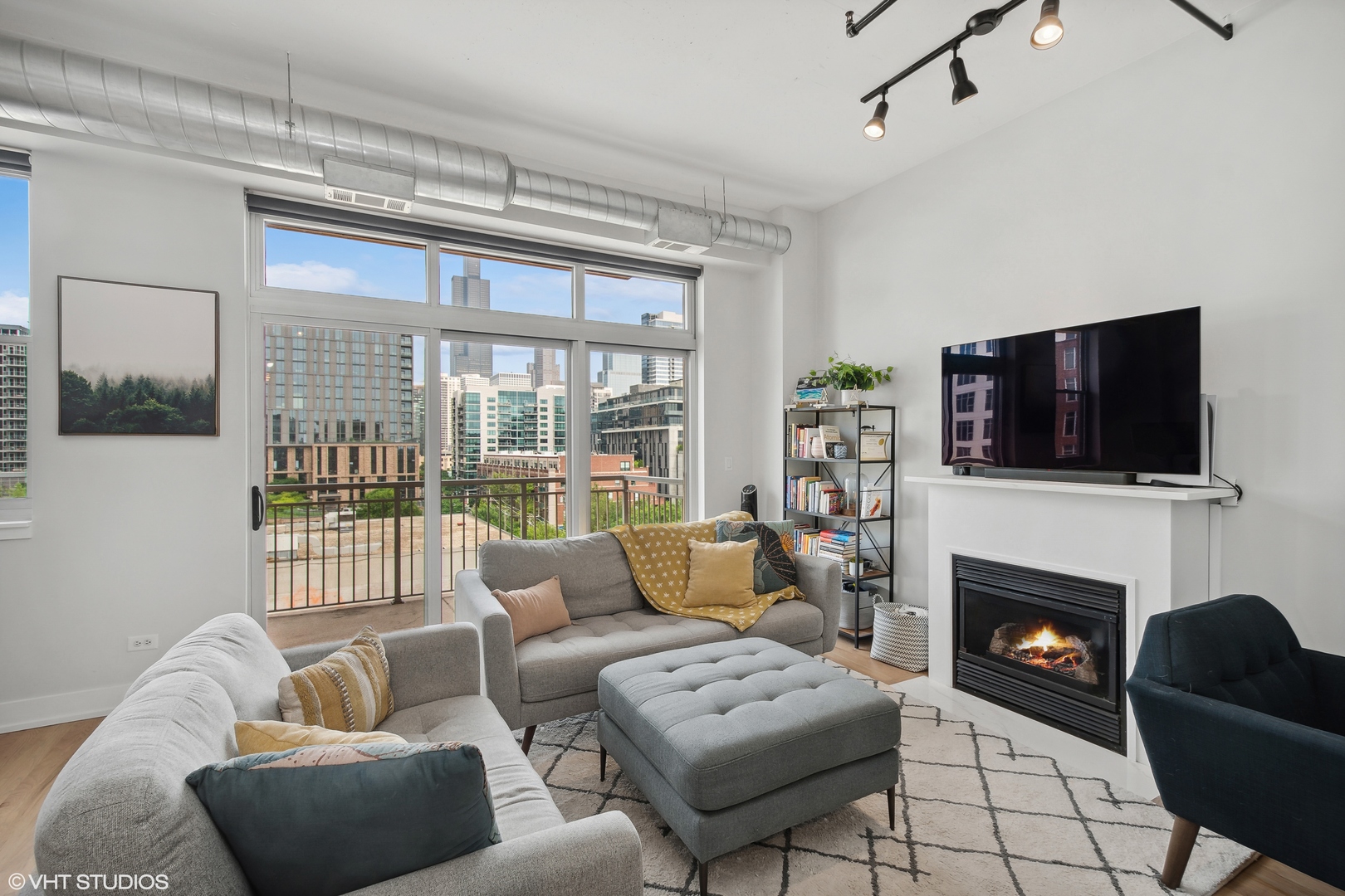 950 West Monroe Street, Unit 602 Chicago, IL 60607 - Photo 4 of 14 a living room with furniture a flat screen tv and a fireplace