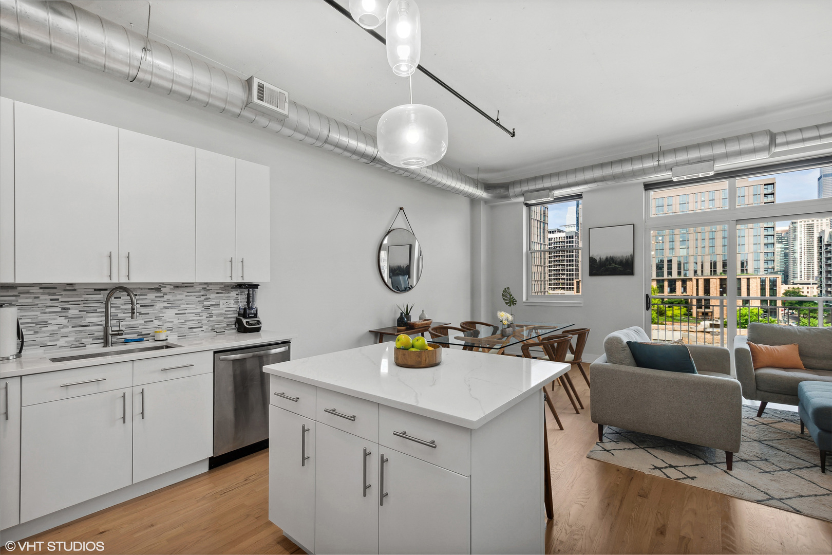 950 West Monroe Street, Unit 602 Chicago, IL 60607 - Photo 5 of 14 a view of a kitchen with a sink stainless steel appliances cabinets and a counter top space