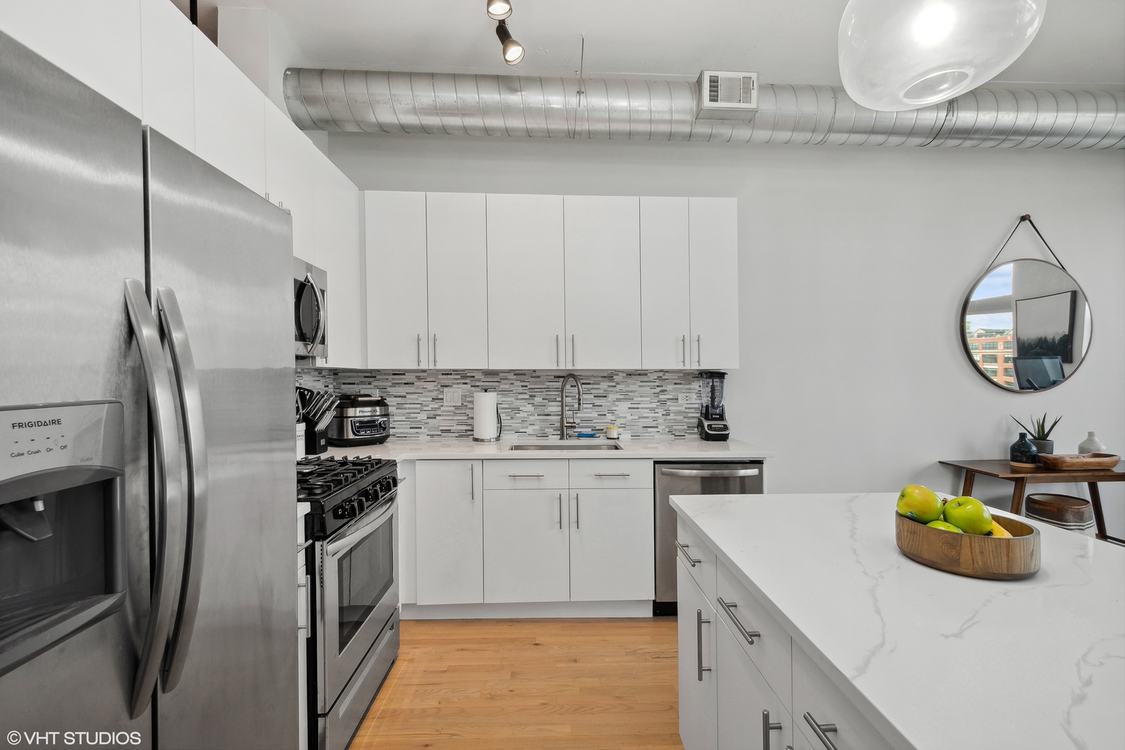 950 West Monroe Street, Unit 602 Chicago, IL 60607 - Photo 7 of 14 a kitchen with stainless steel appliances granite countertop a sink a stove and a refrigerator