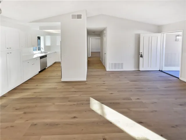 a view of a kitchen cabinets and wooden floor