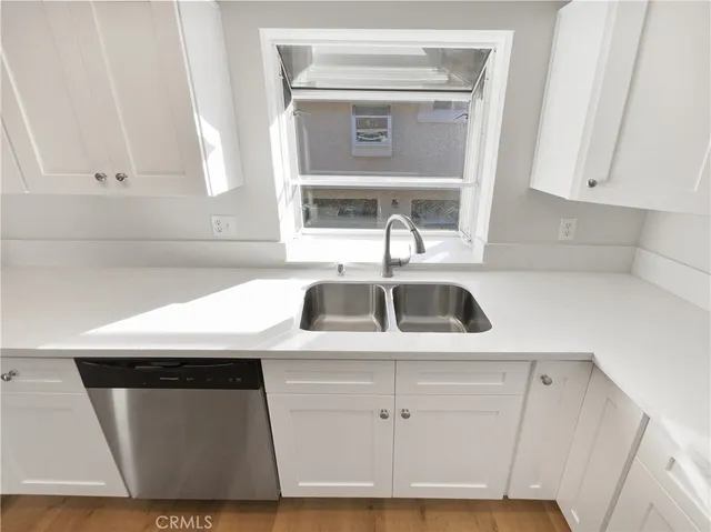 a kitchen with a sink a stove and cabinets
