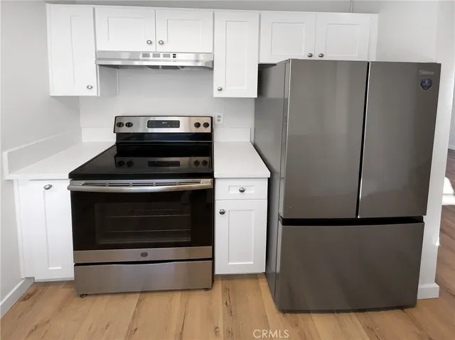 a kitchen with appliances and cabinets