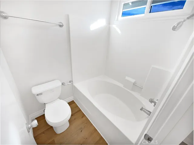 a bathroom with a toilet and a bathtub
