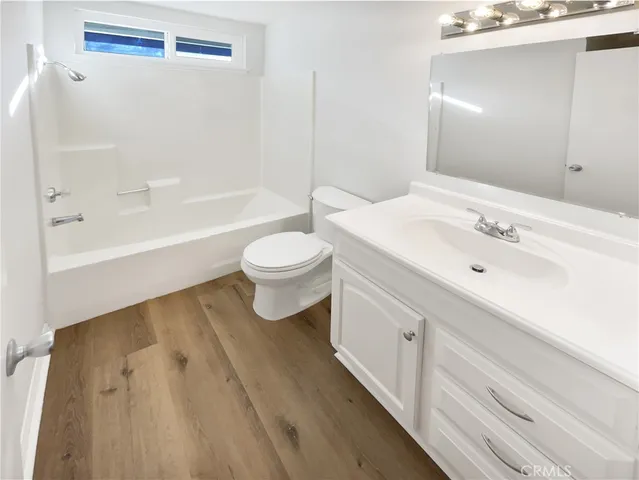 a bathroom with a sink a toilet and bathtub
