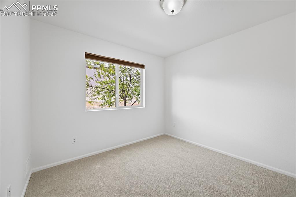 9414 Timberlake Loop Colorado Springs, CO 80927 - Photo 23 of 40 Unfurnished secondary lower-level bedroom with light carpet flooring