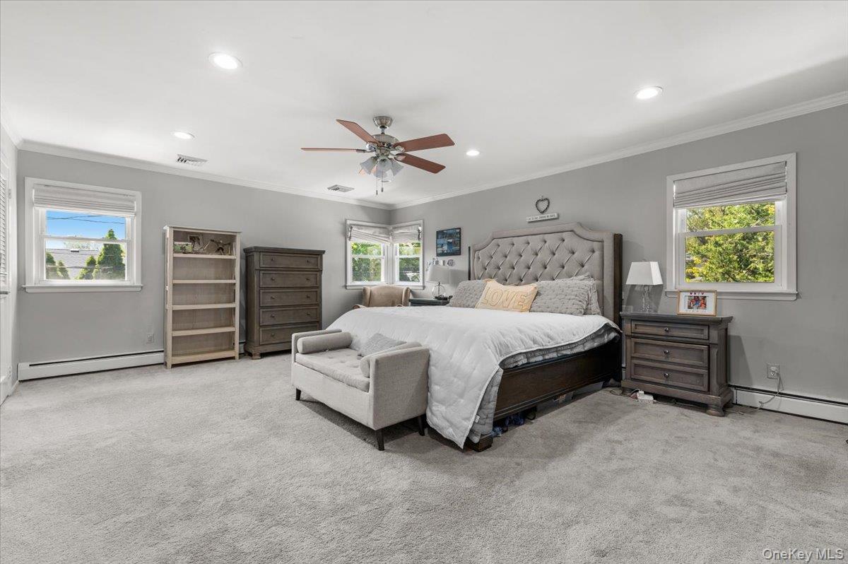 61 Winthrop Road Plainview, NY 11803 - Photo 15 of 37 a spacious bedroom with a bed and dresser