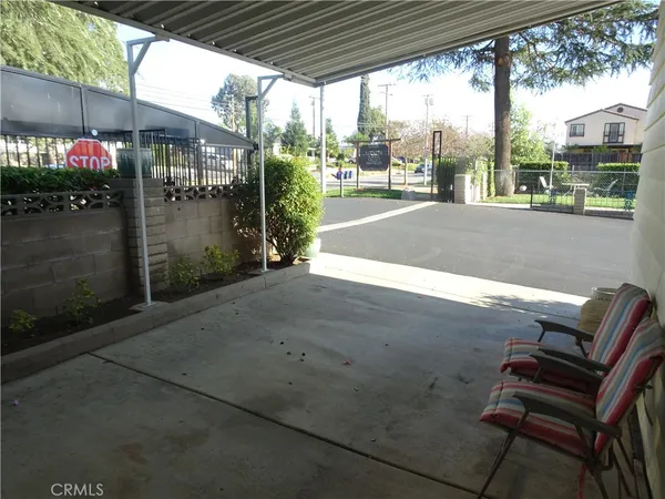 a bedroom with a bed and a dresser with wooden floor