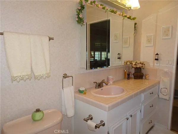 a living room with furniture flowerpot and a chandelier