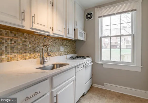a kitchen with sink and cabinets