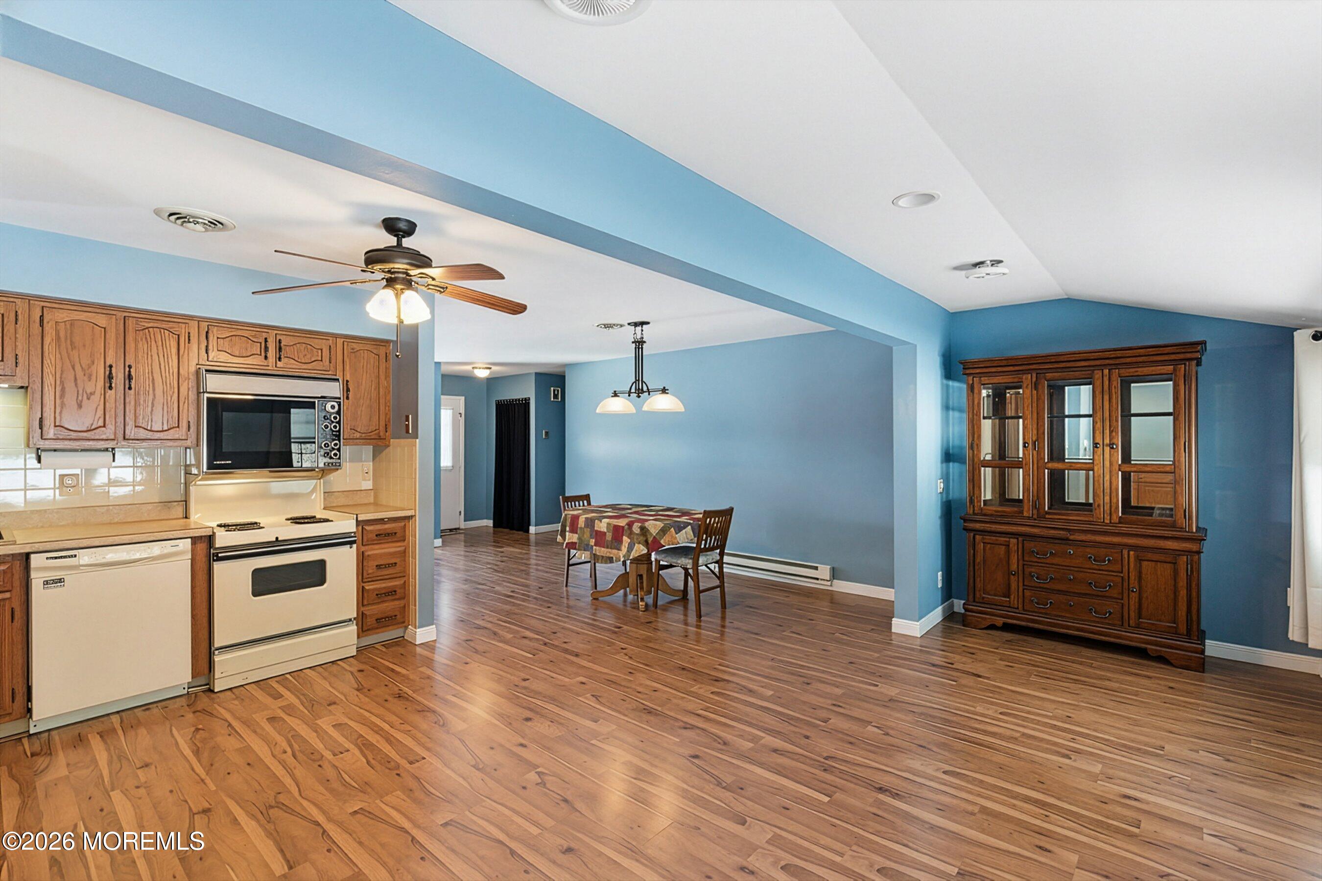 14 Medford Road, Unit 61 Whiting, NJ 08759 - Photo 13 of 36 a kitchen with a stove kitchen island furniture and wooden floor