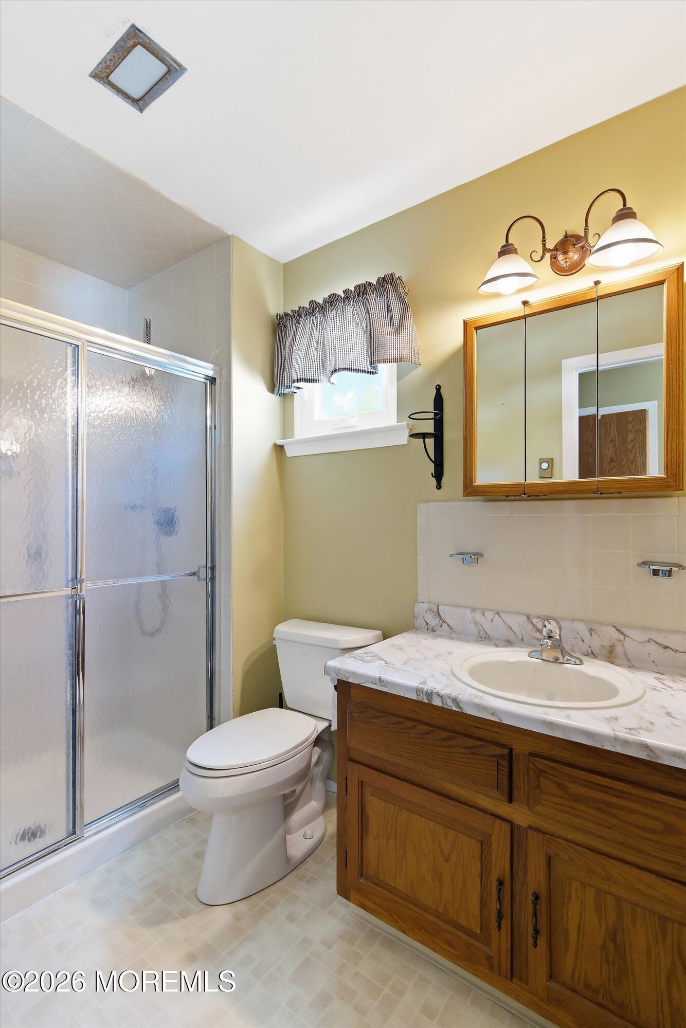 14 Medford Road, Unit 61 Whiting, NJ 08759 - Photo 15 of 36 a bathroom with a sink a toilet and shower