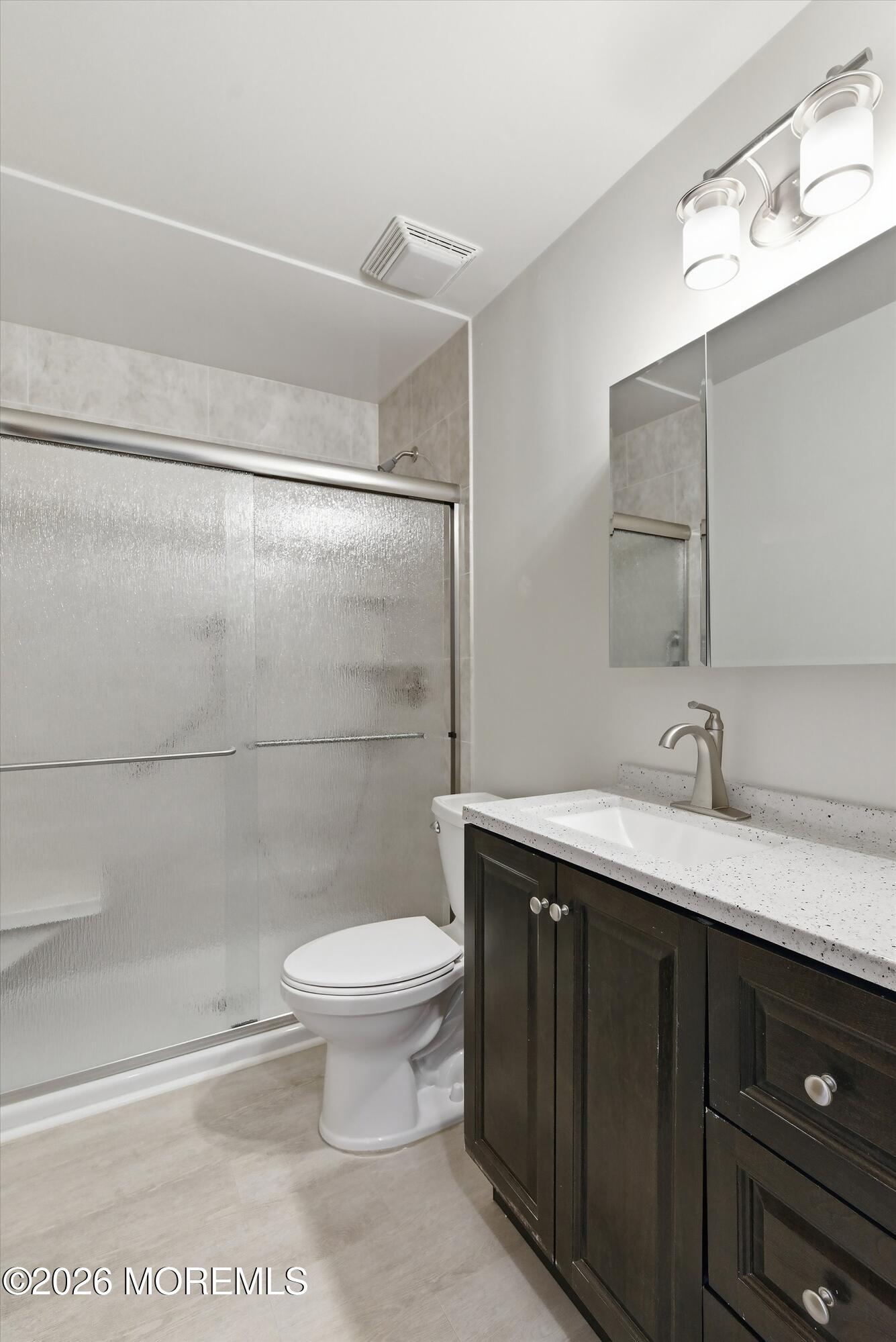 14 Medford Road, Unit 61 Whiting, NJ 08759 - Photo 17 of 36 a bathroom with a granite countertop sink toilet and shower