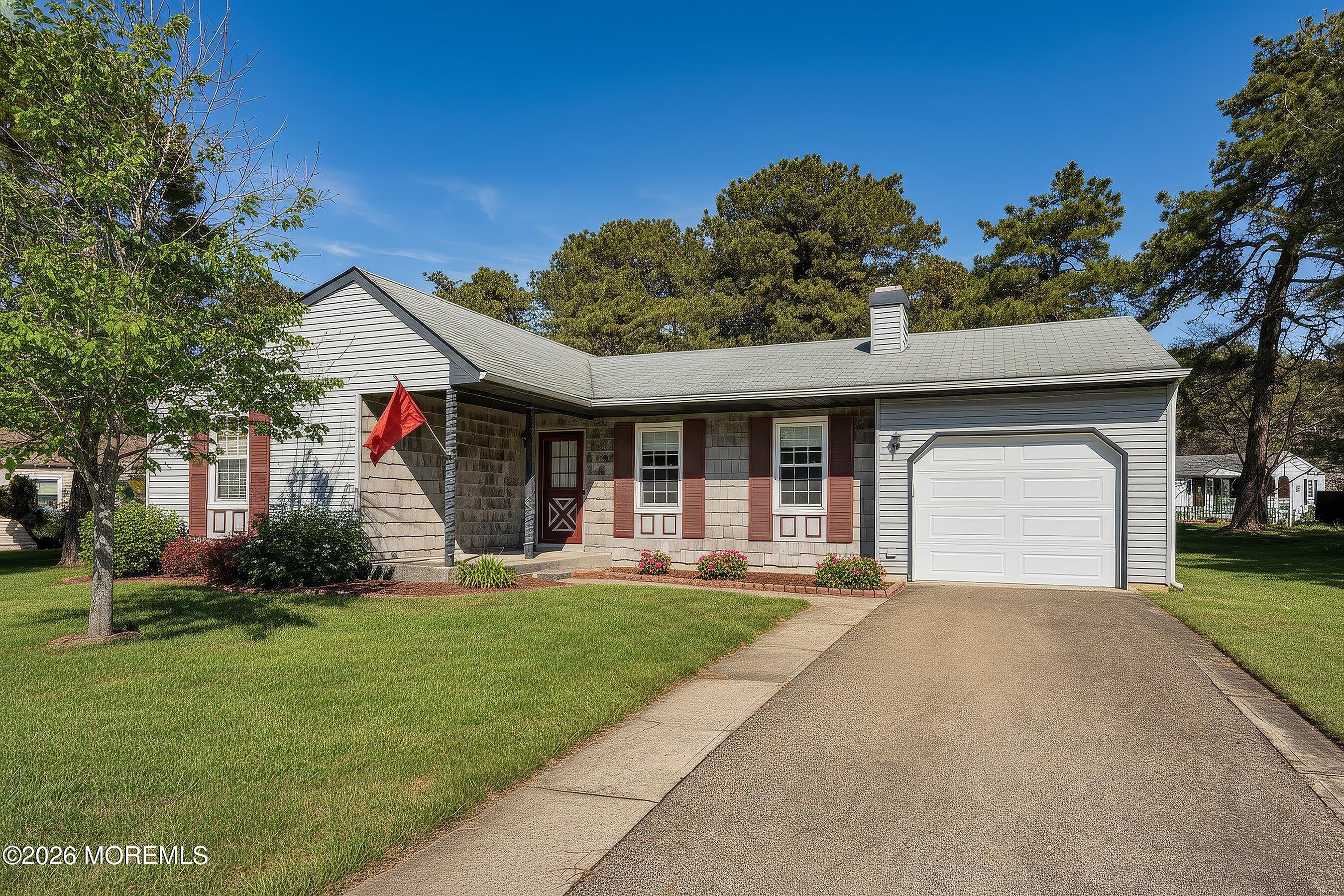 14 Medford Road, Unit 61 Whiting, NJ 08759 - Photo 27 of 36 a front view of a house with a yard and potted plants