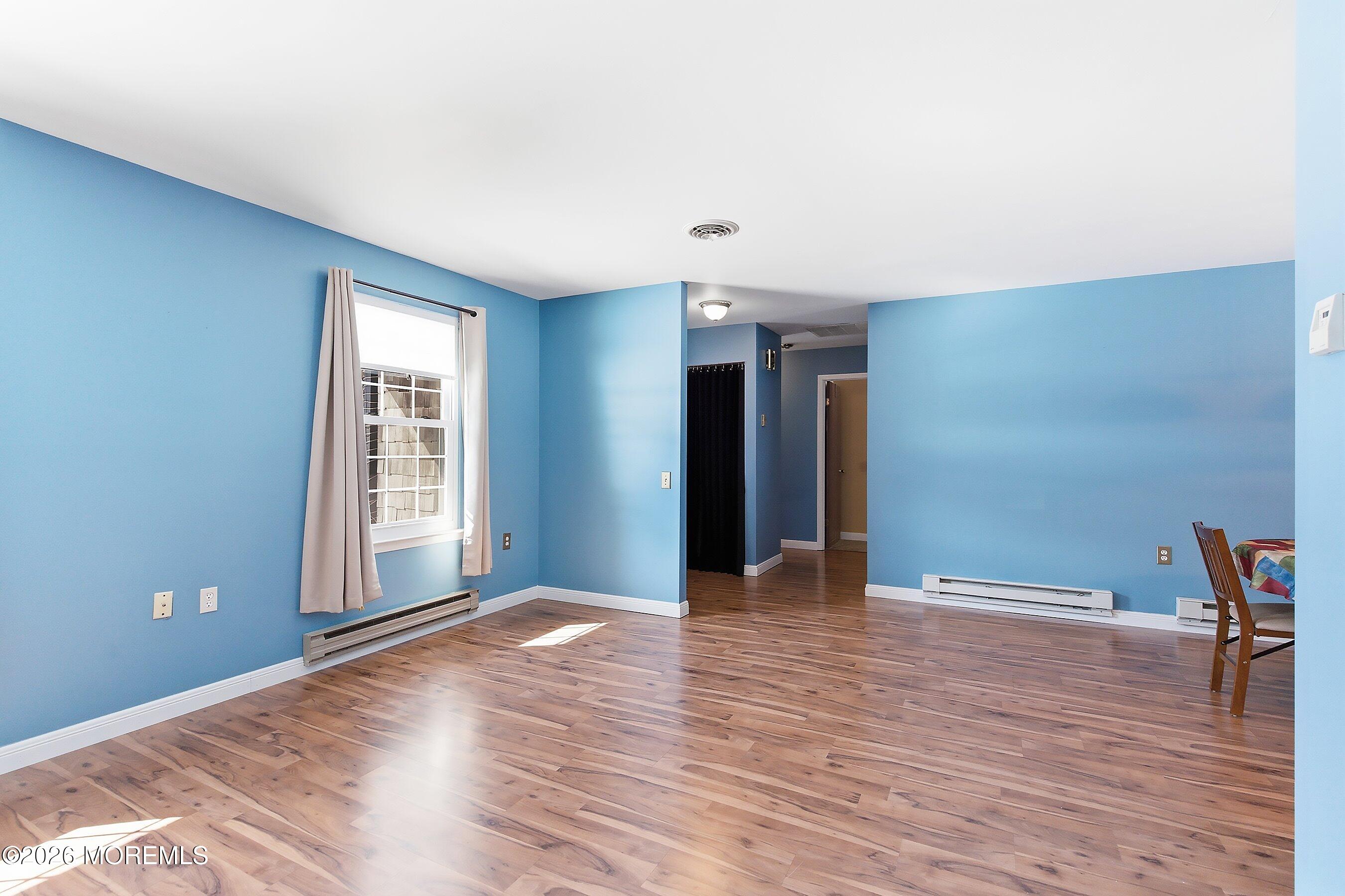 14 Medford Road, Unit 61 Whiting, NJ 08759 - Photo 3 of 36 a view of an empty room with wooden floor and a window