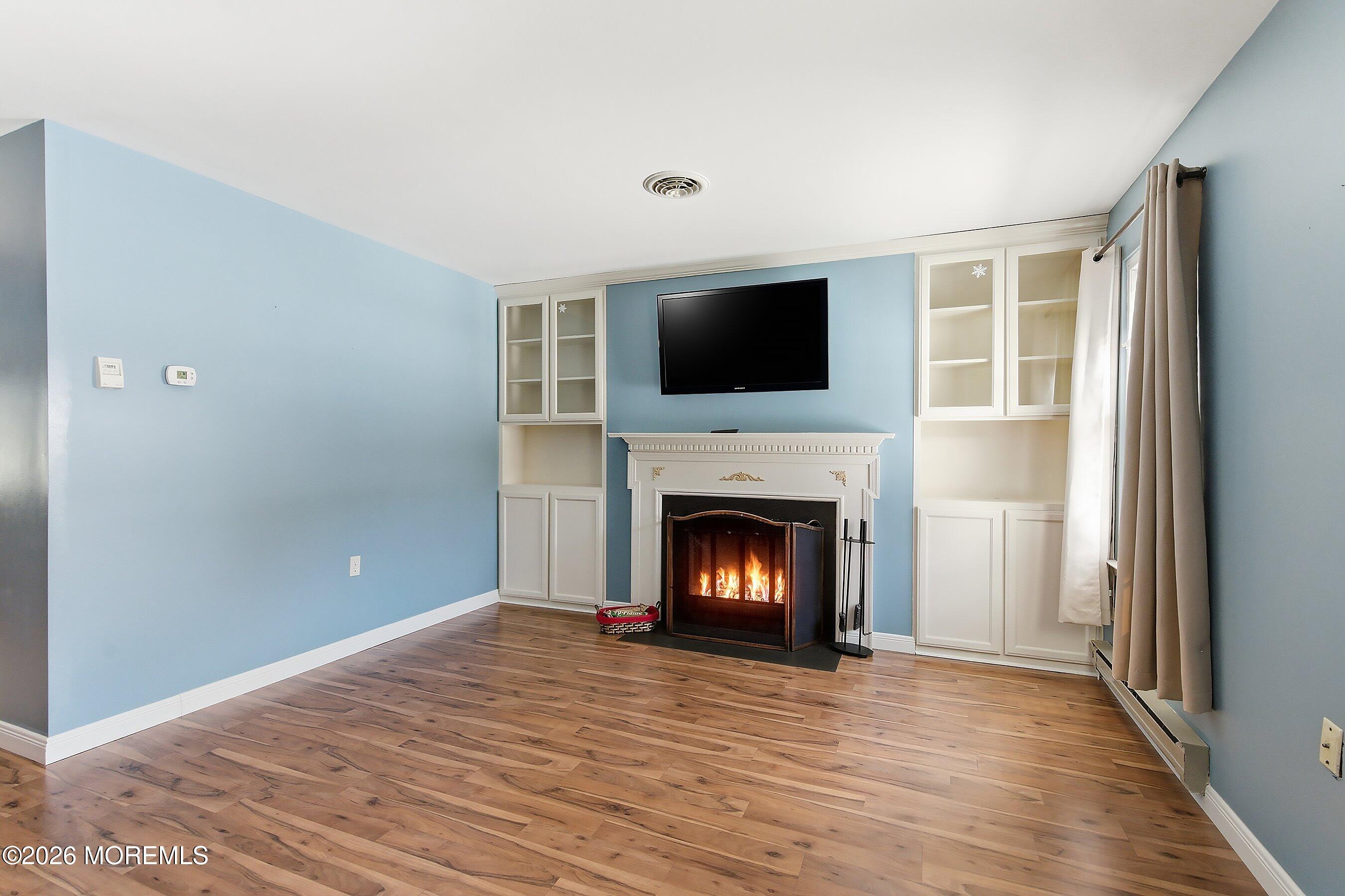 14 Medford Road, Unit 61 Whiting, NJ 08759 - Photo 32 of 36 a view of an empty room with wooden floor fireplace and a window