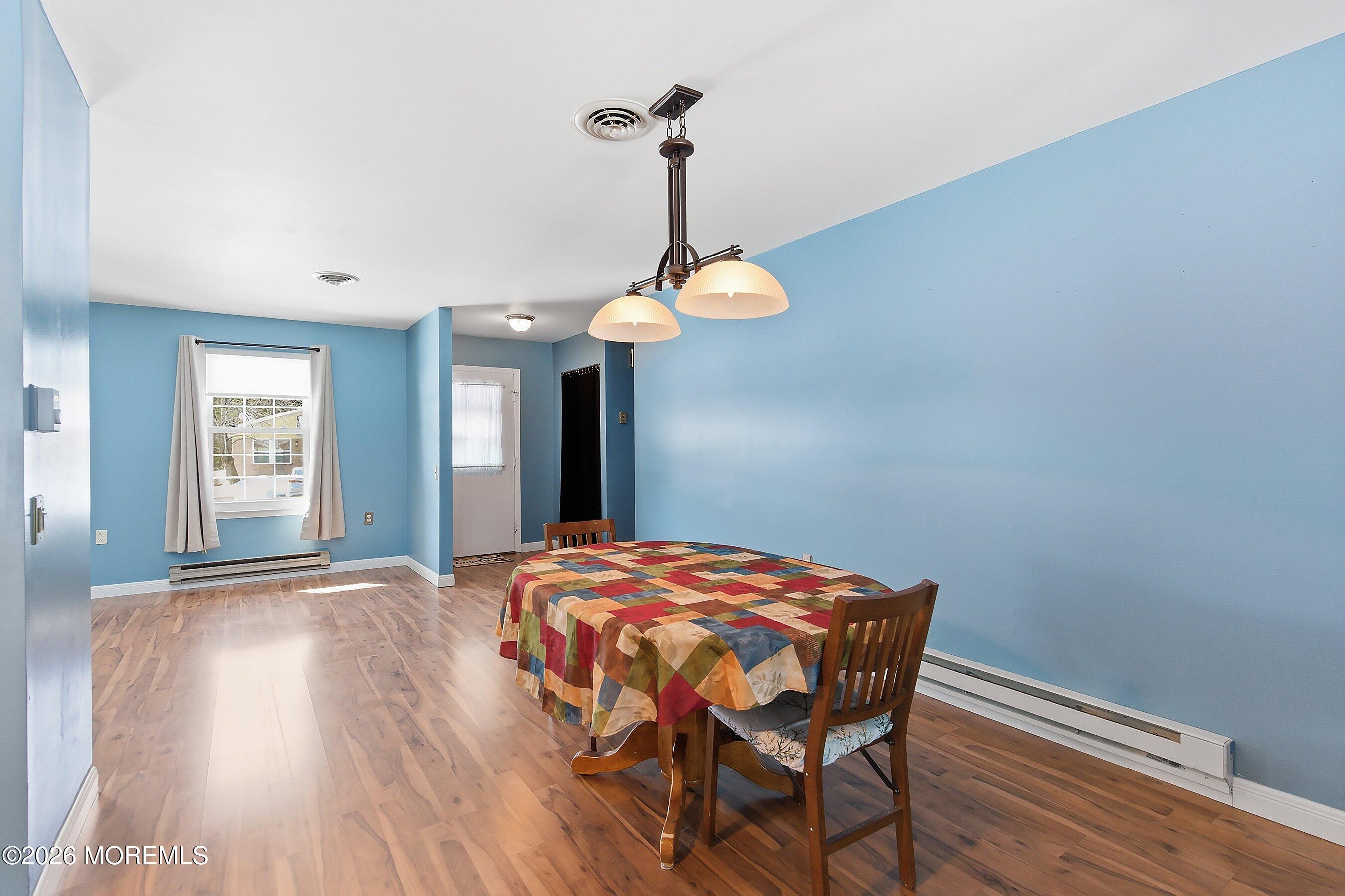 14 Medford Road, Unit 61 Whiting, NJ 08759 - Photo 4 of 36 a bedroom with a bed and a chandelier