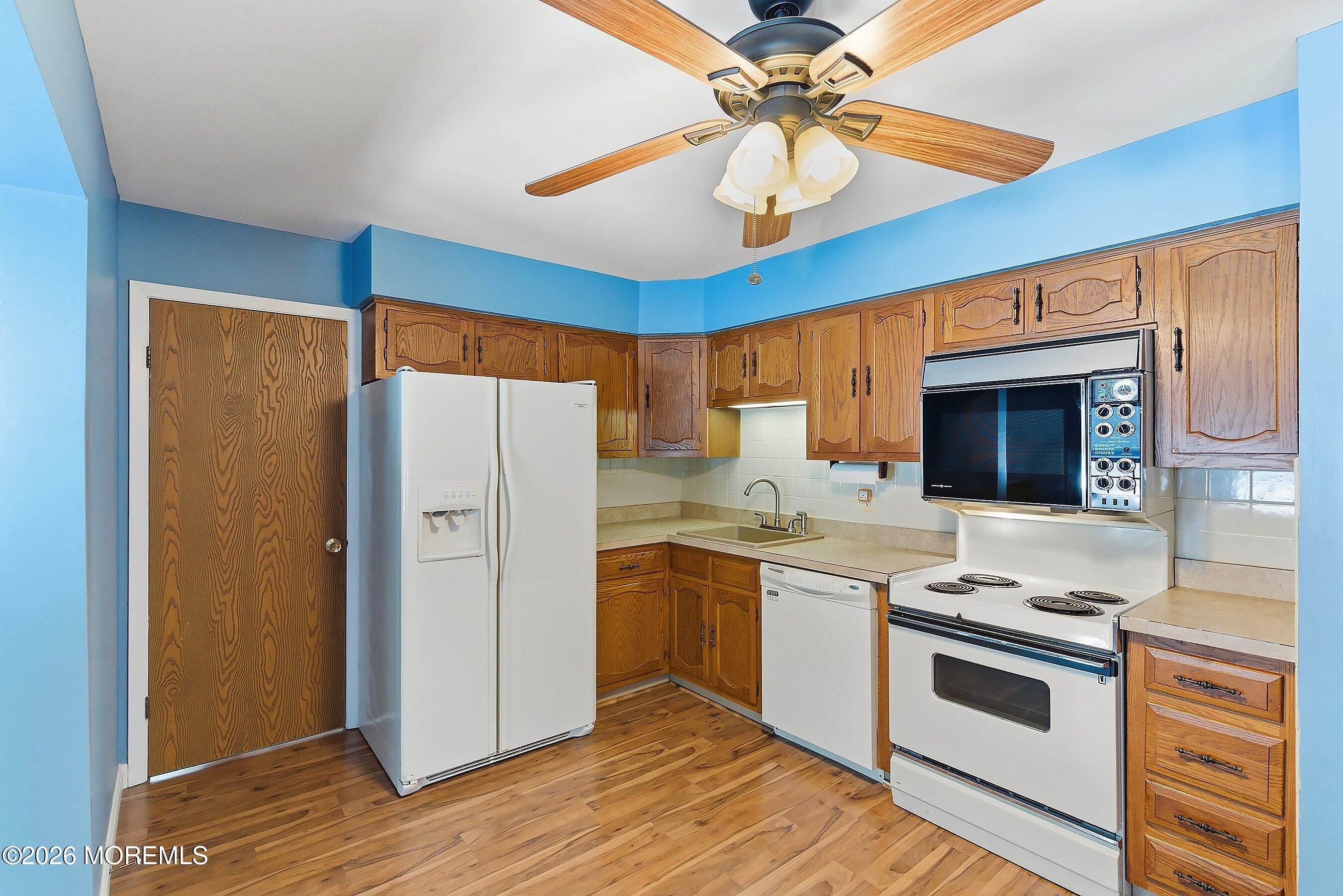 14 Medford Road, Unit 61 Whiting, NJ 08759 - Photo 7 of 36 a kitchen with stainless steel appliances a stove a refrigerator and a sink