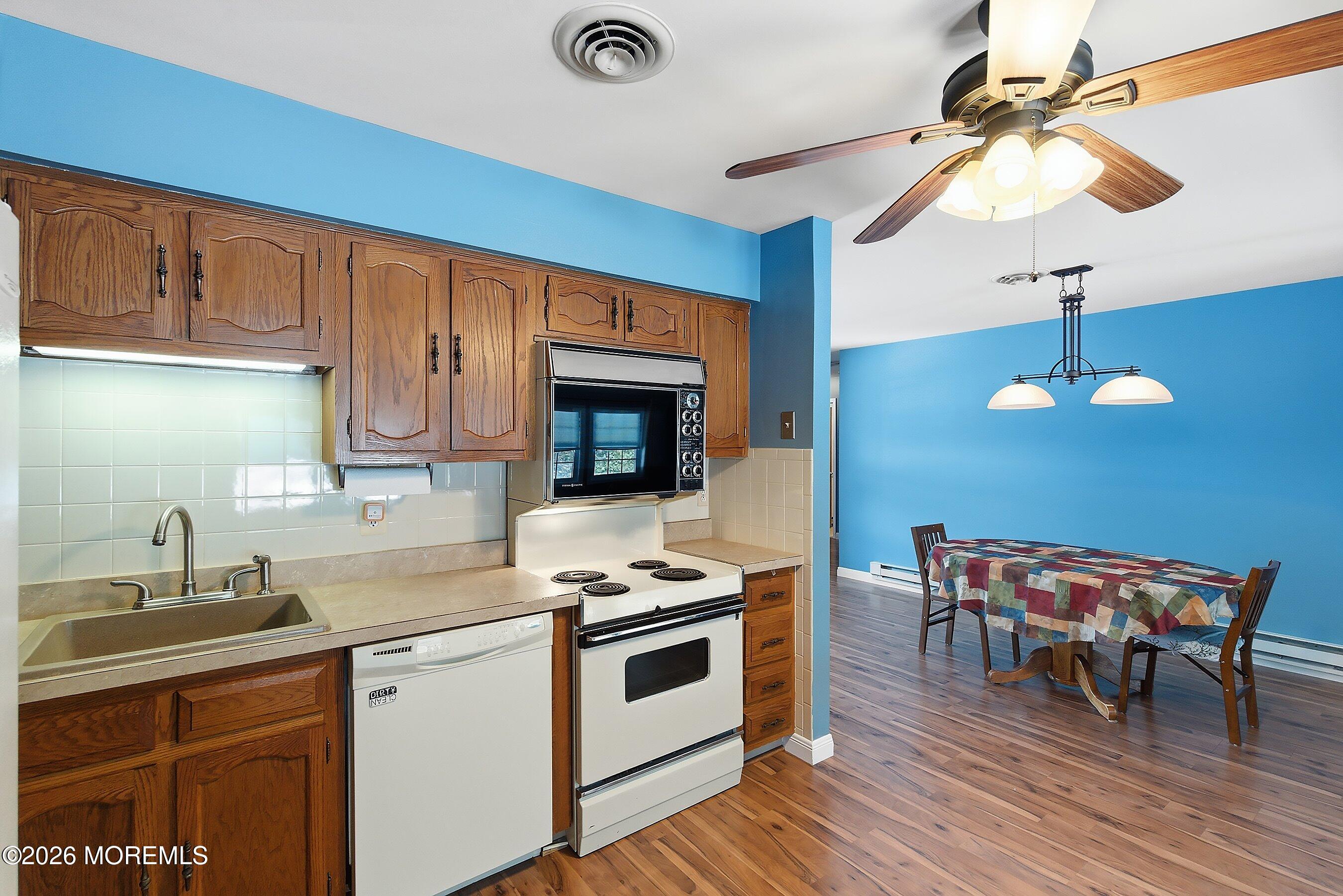 14 Medford Road, Unit 61 Whiting, NJ 08759 - Photo 10 of 36 a kitchen with granite countertop a stove a sink and a refrigerator