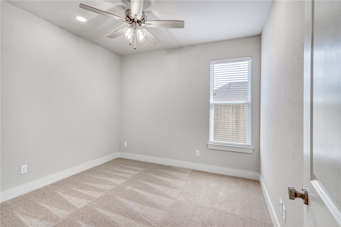 2815 Spector Drive Bryan, TX 77808 - Photo 11 of 15 an empty room with windows and fan