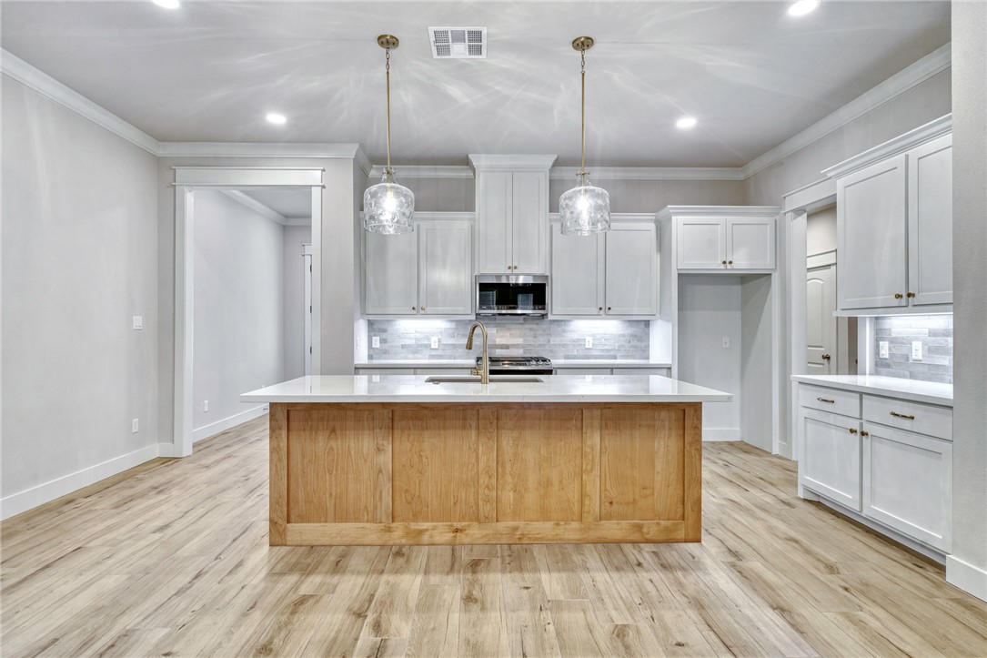 2815 Spector Drive Bryan, TX 77808 - Photo 3 of 15 a large kitchen with granite countertop a large counter top appliances and cabinets