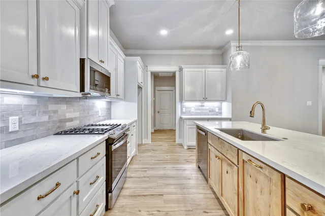 a kitchen with stainless steel appliances granite countertop a sink and stove