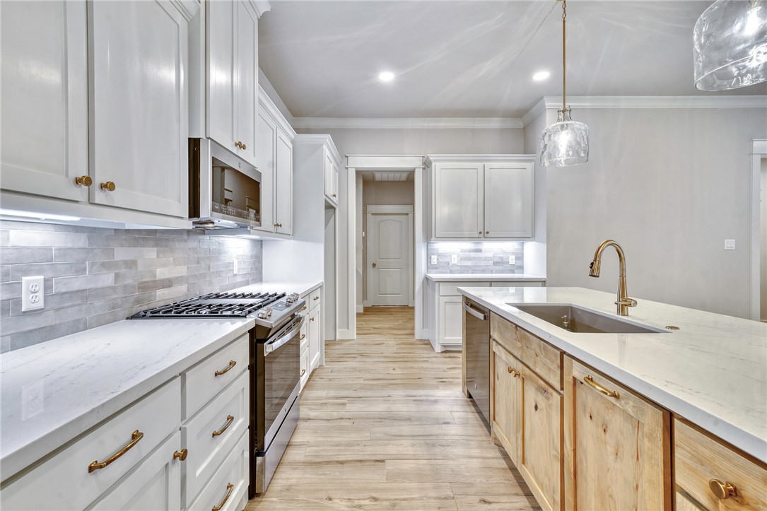 2815 Spector Drive Bryan, TX 77808 - Photo 4 of 15 a kitchen with stainless steel appliances granite countertop a sink and stove