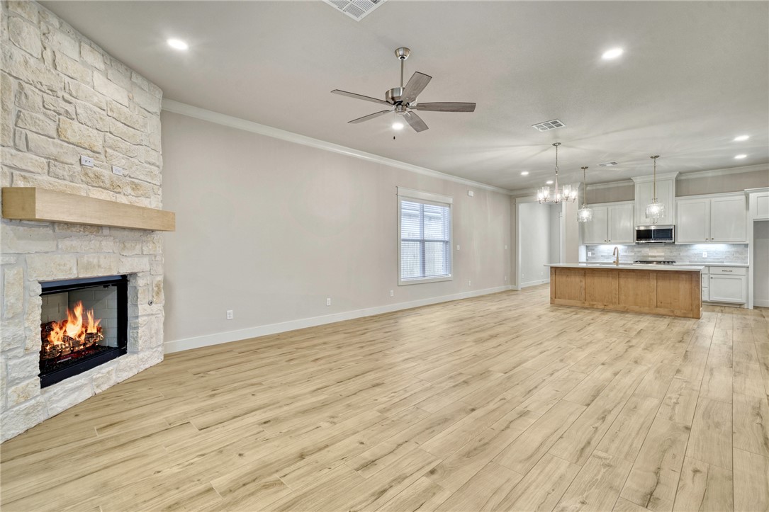 2815 Spector Drive Bryan, TX 77808 - Photo 5 of 15 a view of an empty room with a fireplace and window