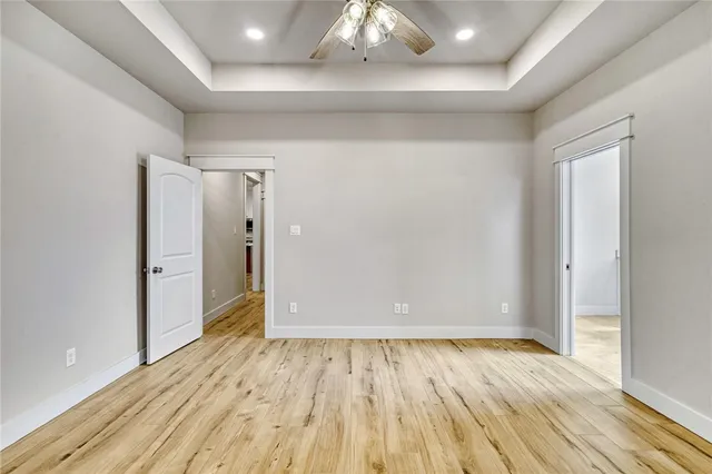 a view of an empty room and wooden floor