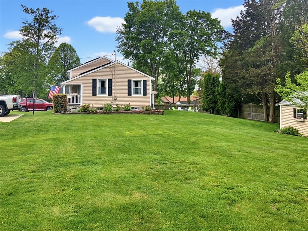 433 Pearse Road Swansea, MA 02777 - Photo 40 of 40 a front view of a house with a yard and trees