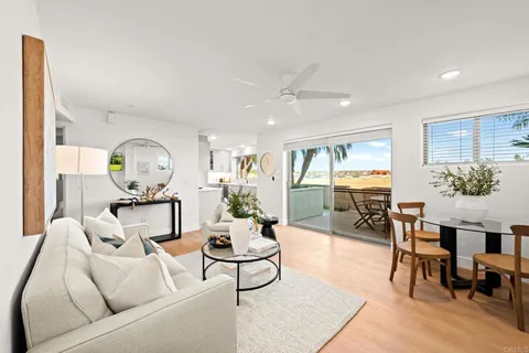 a living room with furniture a table and a potted plant