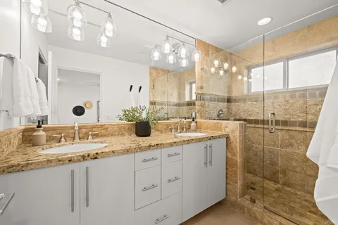 a bathroom with a sink double vanity and a shower