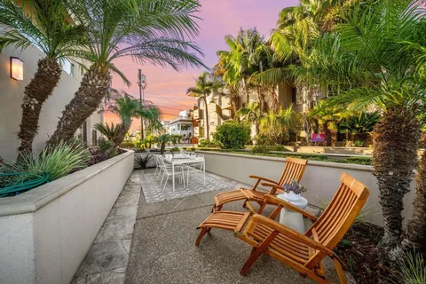 a view of swimming pool with outdoor seating and plants